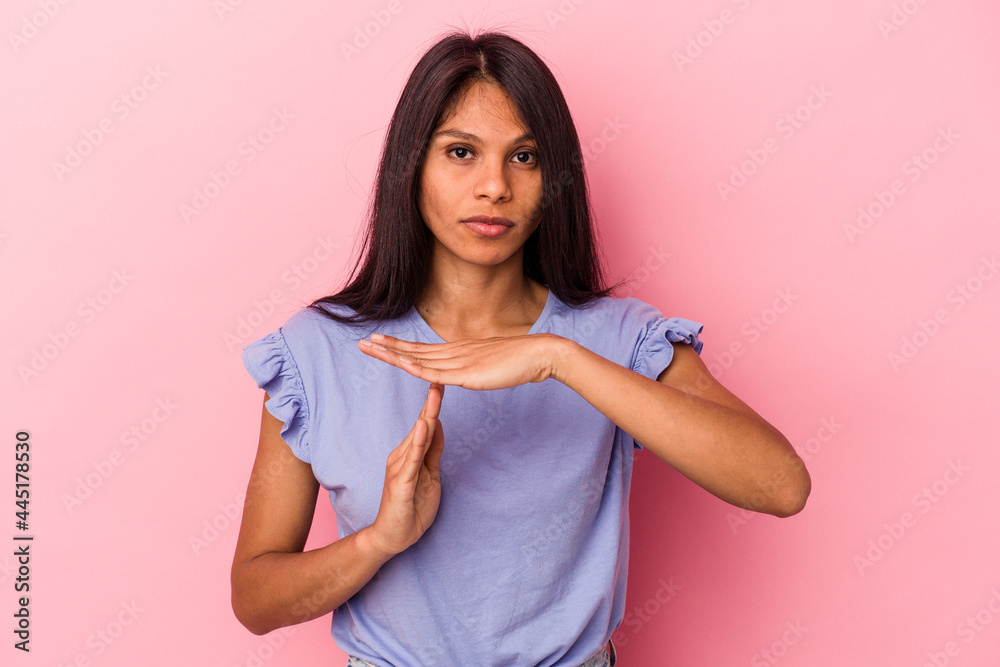 Young latin woman isolated on pink background showing a timeout gesture. Young latin woman isolated on pink background showing a timeout gesture.
