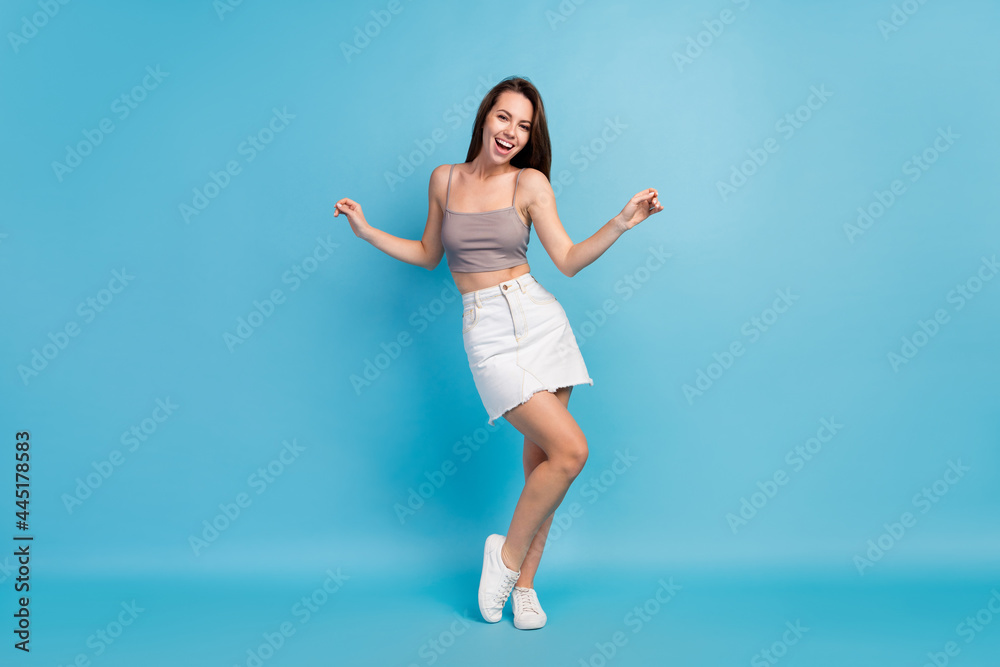 Full length photo of attractive charming young woman wear casual summer outfit isolated on blue color background Full length photo of attractive charming young woman wear casual summer outfit isolated on blue color background