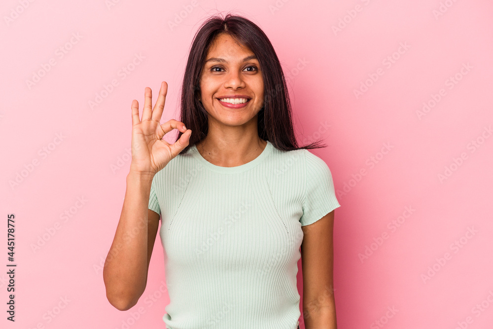 Young latin woman isolated on pink background cheerful and confident showing ok gesture. Young latin woman isolated on pink background cheerful and confident showing ok gesture.