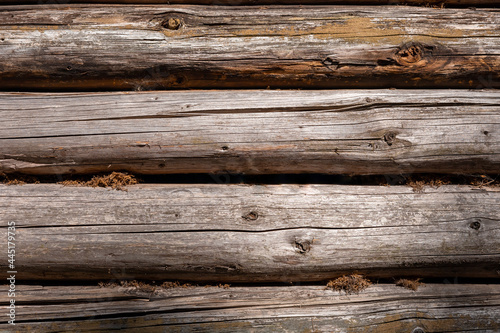 An old cottage wall, made of wooden logs. A background with copyspace. 