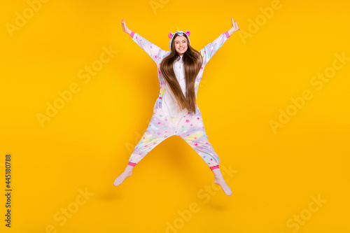 Full length body size view of attractive cheerful girl having fun jumping isolated over bright yellow color background