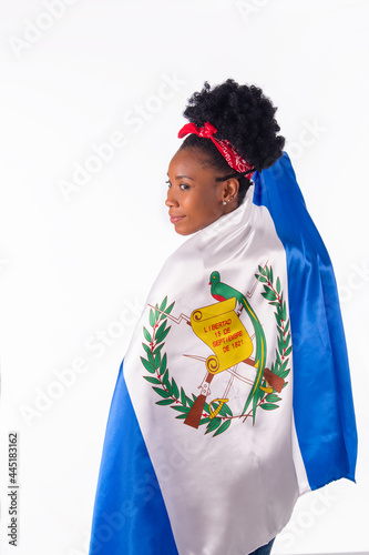 Latina woman wrapped in a Guatemalan flag with a smile: Flags and diversity concept.