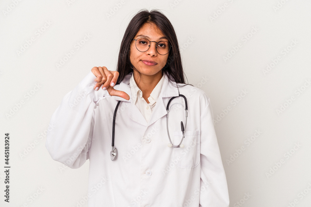 Young doctor latin woman isolated on white background showing a dislike gesture, thumbs down. Disagreement concept. Young doctor latin woman isolated on white background showing a dislike gesture, thumbs down. Disagreement concept.