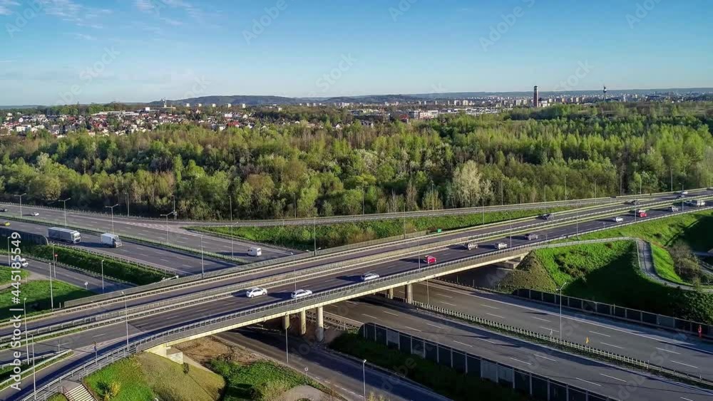 Motorway multilevel crossing. Spaghetti junction on A4 international highway, the part of orbital road around Krakow, Poland. Aerial 4K panning video in spring. Motorway multilevel crossing. Spaghetti junction on A4 international highway, the part of orbital road around Krakow, Poland. Aerial 4K panning video in spring.