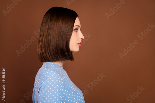 Profile photo of nice brunette millennial lady look wear dotted shirt isolated on brown color background photo