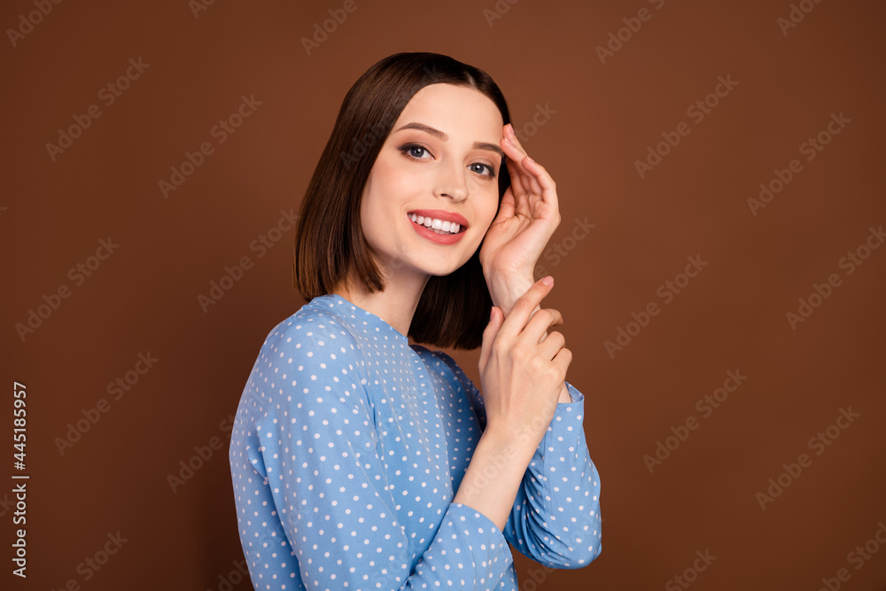 Photo of lovely short hairdo young lady touch face wear blue blouse isolated on brown color background Photo of lovely short hairdo young lady touch face wear blue blouse isolated on brown color background