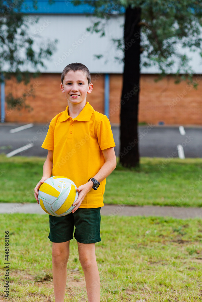 Portrait of Australian primary school child with ball during PE Portrait of Australian primary school child with ball during PE