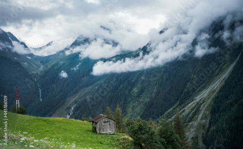 Austrian Alps. Mountain landscape cloudy sky and green meadow.