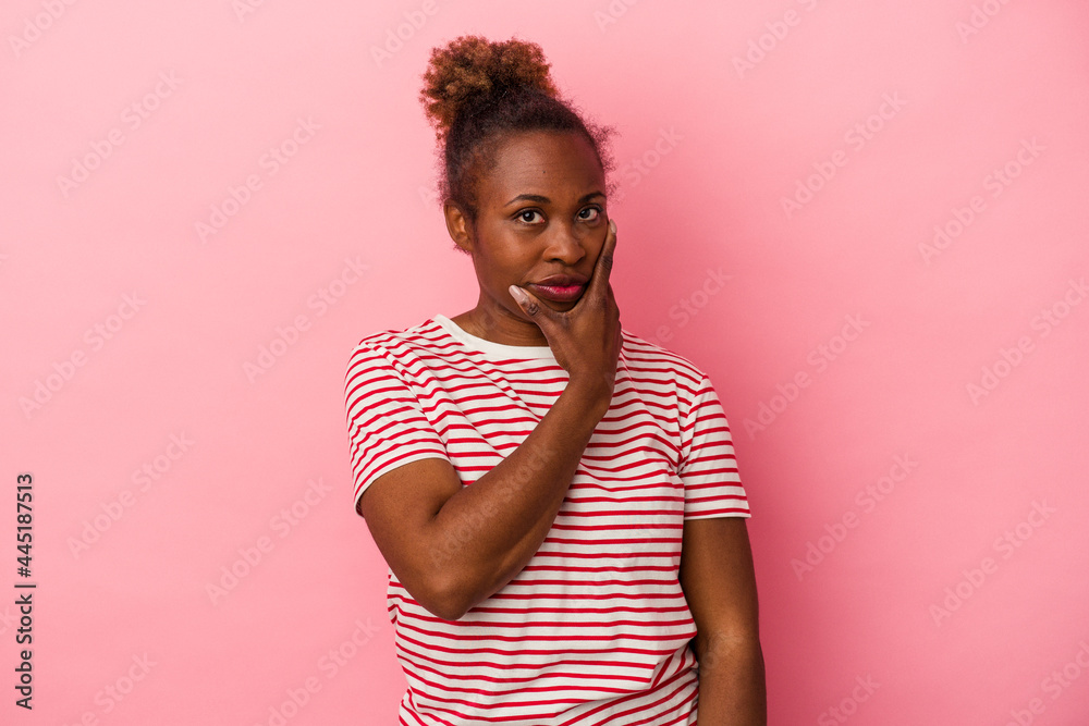 Young african american woman isolated on pink background contemplating, planning a strategy, thinking about the way of a business. Young african american woman isolated on pink background contemplating, planning a strategy, thinking about the way of a business.