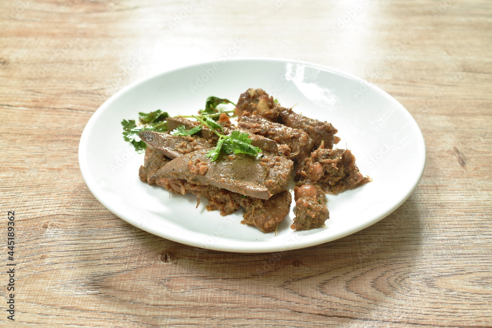 fried slice pork meat and liver with garlic couple pepper topping parsley on plate fried slice pork meat and liver with garlic couple pepper topping parsley on plate