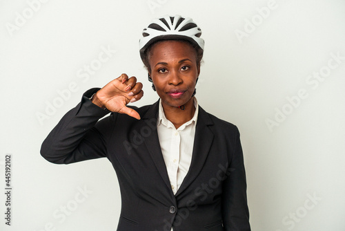Young business african american woman wearing a bike helmet isolated on white background showing a dislike gesture, thumbs down. Disagreement concept. © Asier