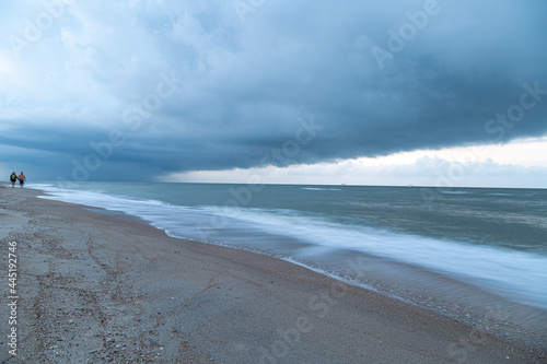 Thunderous gloomy clouds on the sea coast before dawn