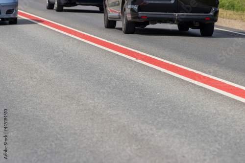 Asphalt road with double lane road stripes  white and red © Alex 