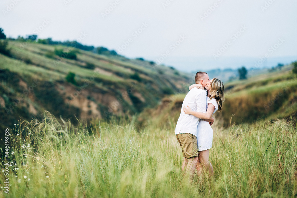 a guy with a girl in light clothes on the background of a green canyon