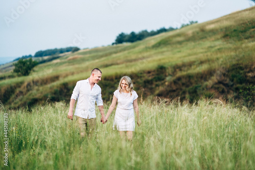 a guy with a girl in light clothes on the background of a green canyon