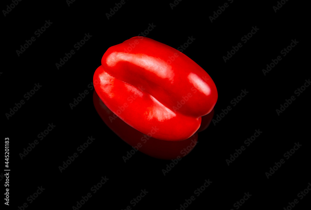Red bell pepper vegetable on a black background. Red pepper. Harvest vegetables. Agricultural business. Food. Vegetarian food. Farm products. Background image. Red bell pepper vegetable on a black background. Red pepper. Harvest vegetables. Agricultural business. Food. Vegetarian food. Farm products. Background image.