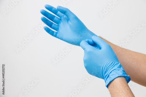 Man wearing blue latex nitrile groves