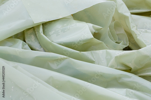 Folds of a green plastic tarpaulin