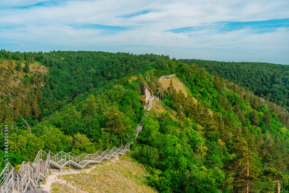Fototapeta premium Stairs in the forest in the mountains. Beautiful natural landscape of Russia near the Volga River.