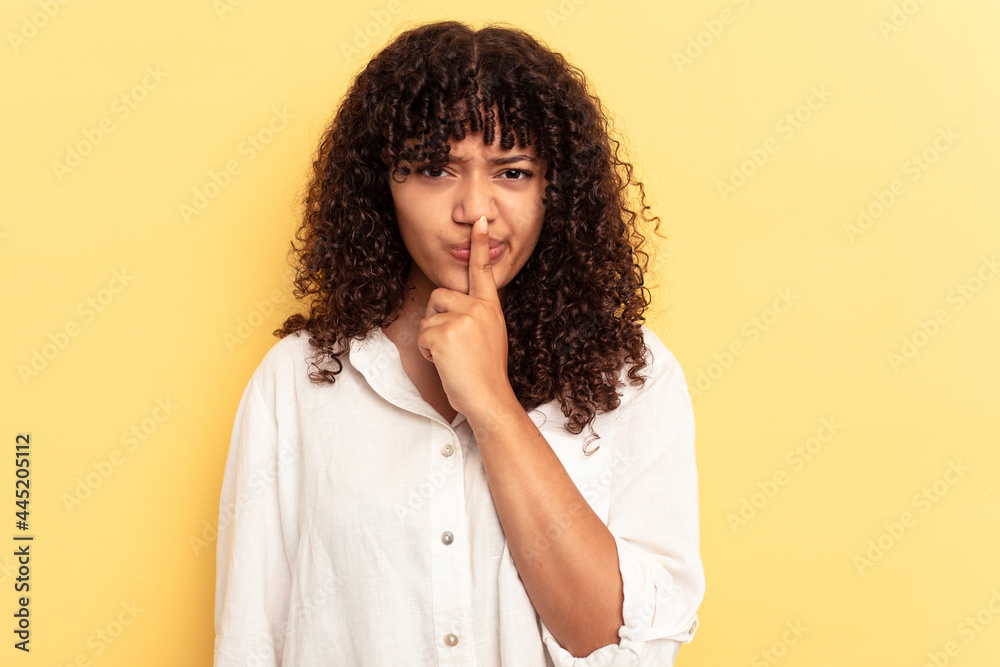 Young mixed race woman isolated on yellow background thinking and looking up, being reflective, contemplating, having a fantasy. Young mixed race woman isolated on yellow background thinking and looking up, being reflective, contemplating, having a fantasy.
