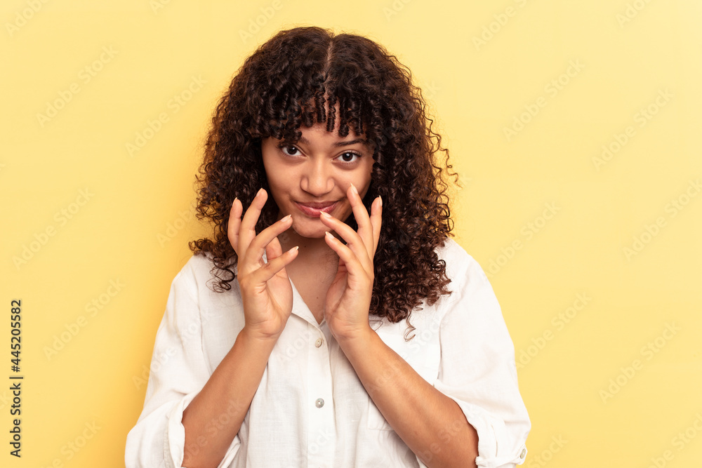 Young mixed race woman isolated on yellow background making up plan in mind, setting up an idea. Young mixed race woman isolated on yellow background making up plan in mind, setting up an idea.