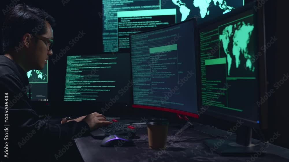 Asian Male Hacker Hacking With Multiple Computer Screens In Dark Room
Asian Male Hacker Hacking With Multiple Computer Screens In Dark Room