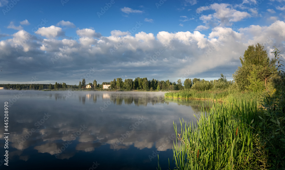 Summer dawn on the Ural lake with fog, Russia