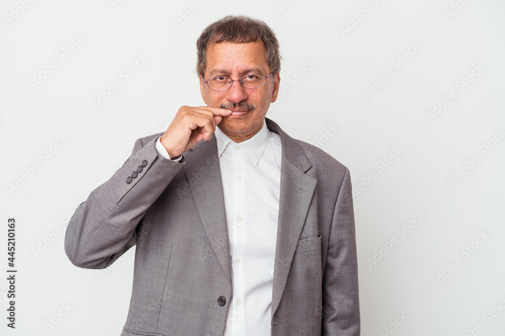 Middle aged indian business man isolated on white background with fingers on lips keeping a secret. Middle aged indian business man isolated on white background with fingers on lips keeping a secret.