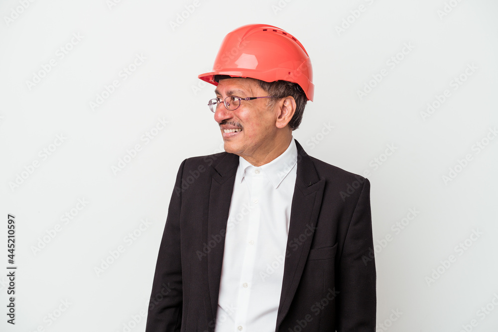 Middle aged indian architect man isolated on white background looks aside smiling, cheerful and pleasant. Middle aged indian architect man isolated on white background looks aside smiling, cheerful and pleasant.