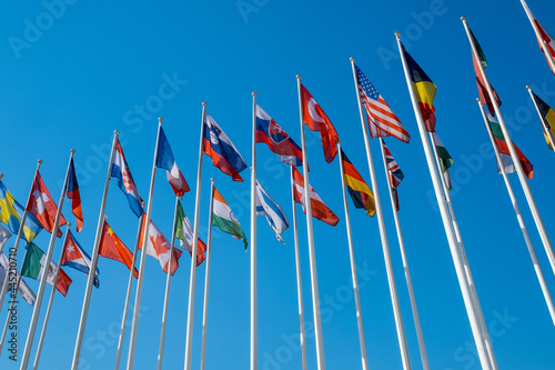 Different flags fluttering on flagpoles