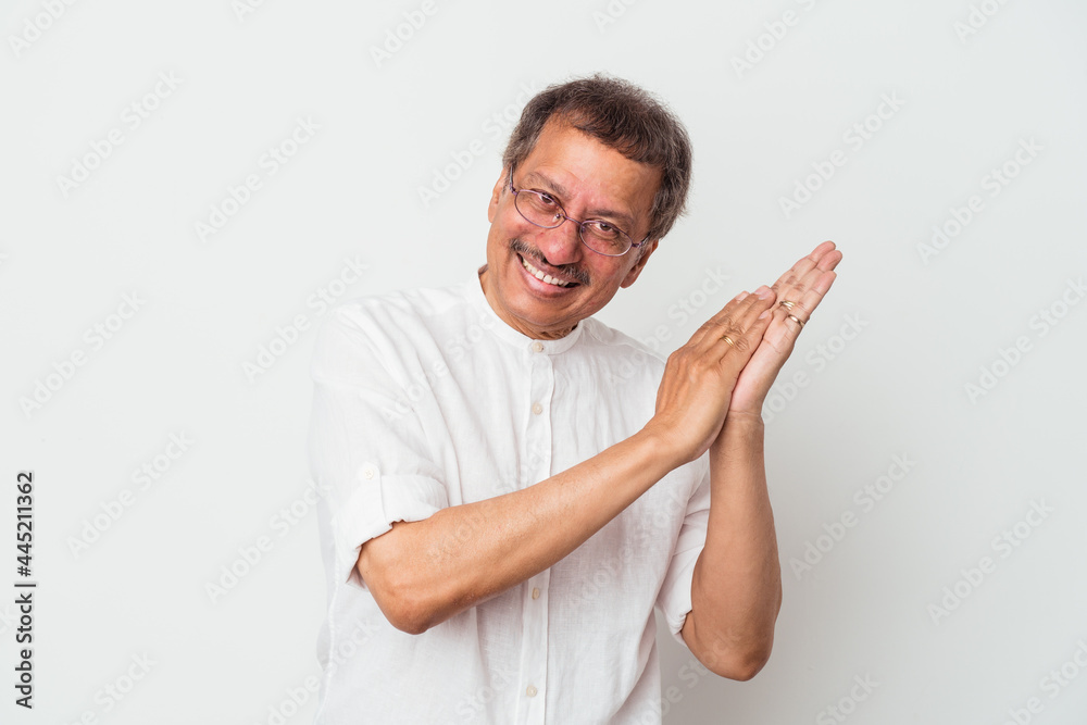Middle aged indian man isolated on white background feeling energetic and comfortable, rubbing hands confident.