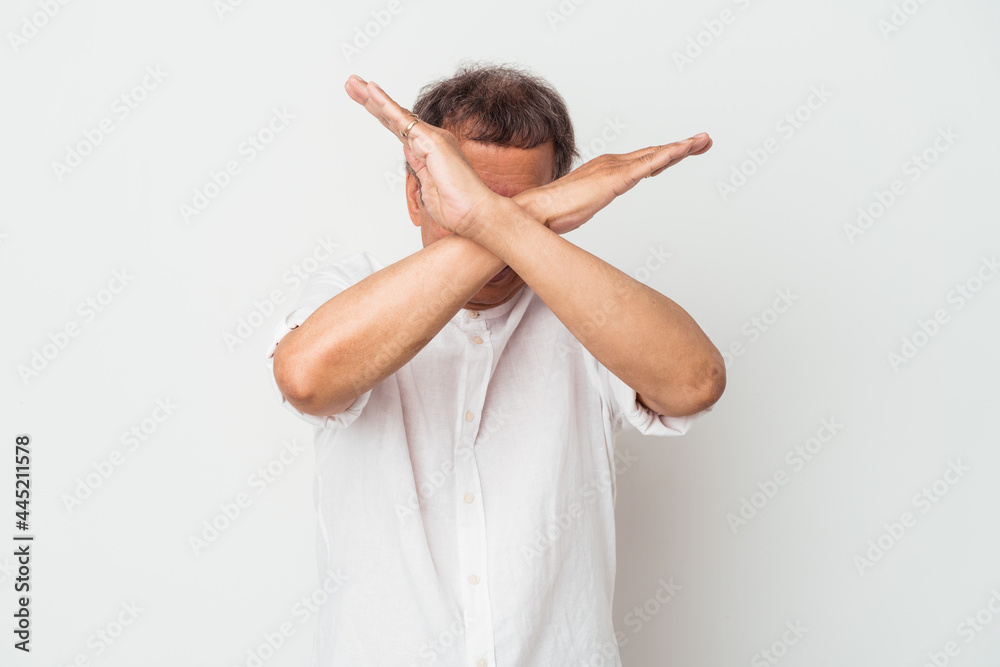 Middle aged indian man isolated on white background keeping two arms crossed, denial concept. Middle aged indian man isolated on white background keeping two arms crossed, denial concept.