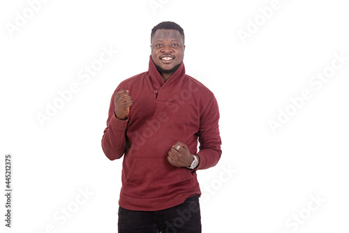 young man making a winning gesture smiling.