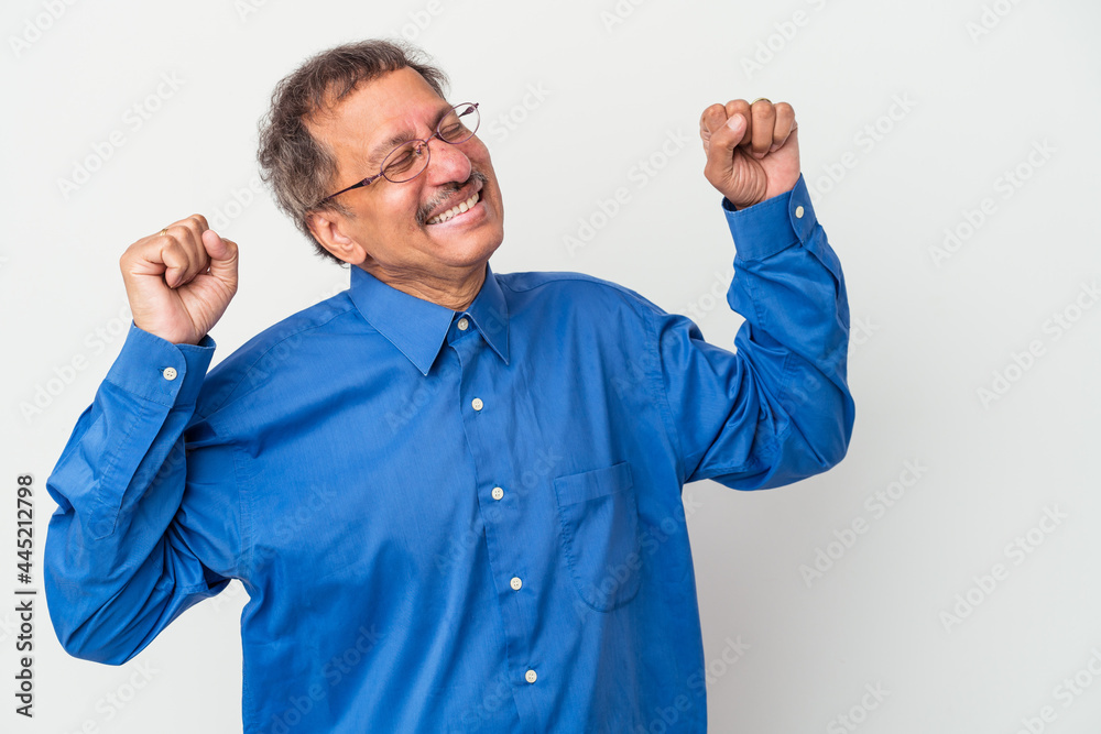 Fototapeta premium Middle aged indian man isolated on white background celebrating a special day, jumps and raise arms with energy.