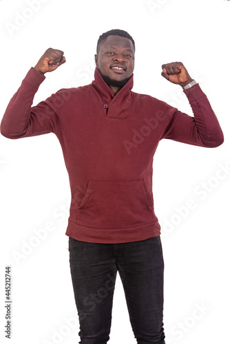 young man making a winning gesture smiling.