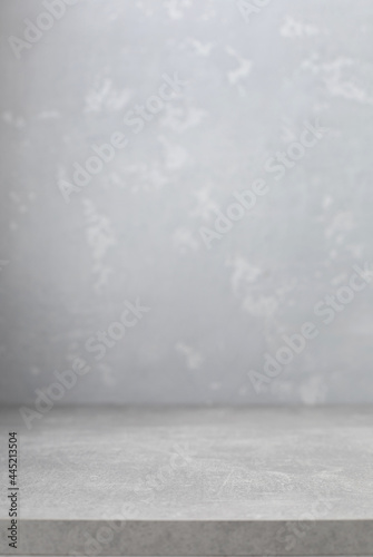 Grey table top and  wall background texture. Front view of tabletop and wall