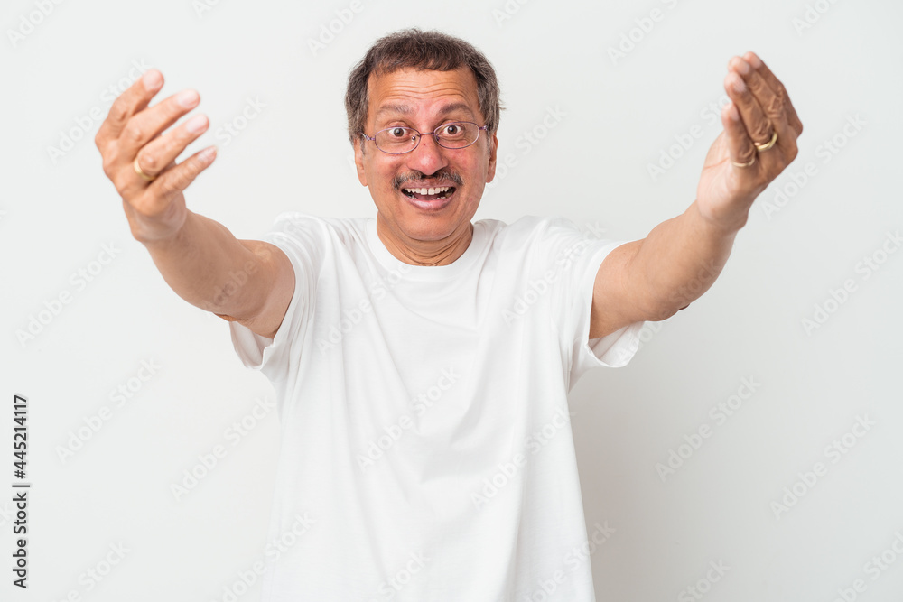 Fototapeta premium Middle aged indian man isolated on white background celebrating a victory or success, he is surprised and shocked.