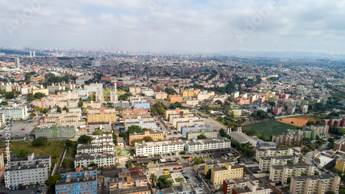 Aerial view of Itaquera, Sao Paulo. Residential buildings, avenues and train © Pedro