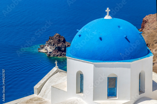 White and blue architecture with churches of Oia village on Santorini island, Greece
