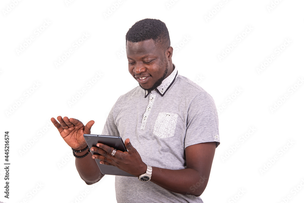 young man using a digital tablet smiling. young man using a digital tablet smiling.