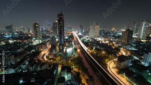 Time lapse shot of night life in the big city, lighted skyscraper, traffic, intersection, Bangkok, Thailand