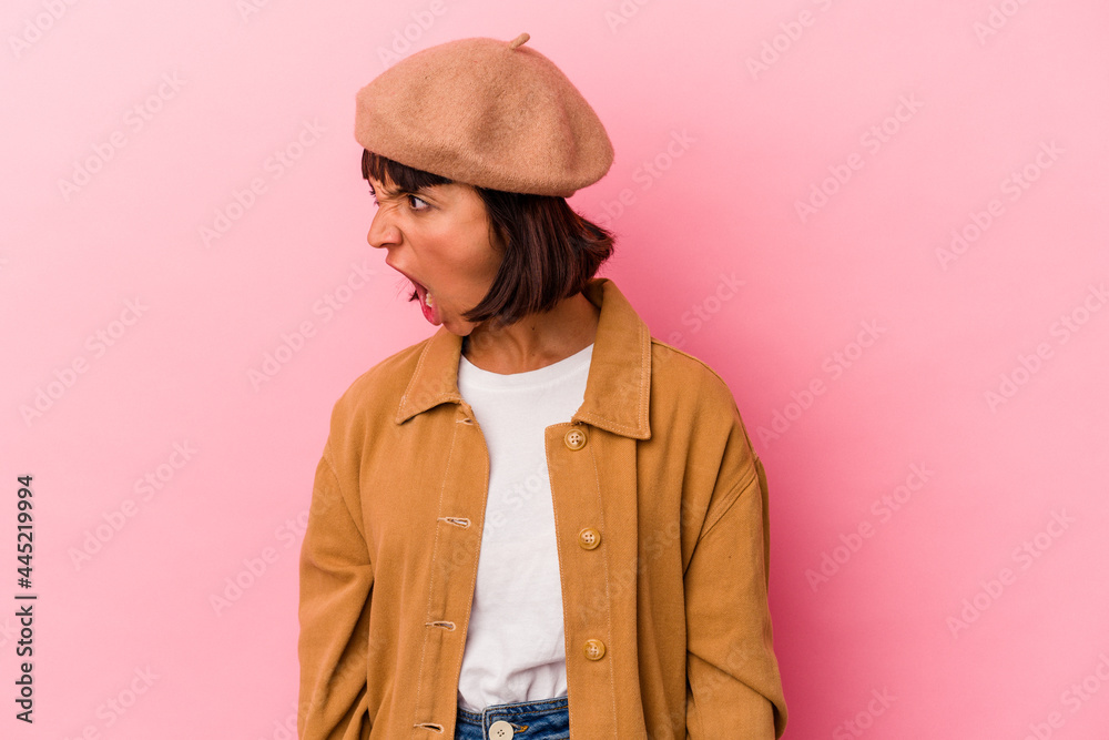 Young mixed race woman isolated on pink background shouting very angry, rage concept, frustrated. Young mixed race woman isolated on pink background shouting very angry, rage concept, frustrated.