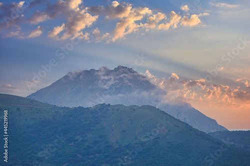 sunlight coming through the mountains and cloud clusters. clouds, sky and vulconic mountain view of Samothrace-Semadirek island from Gokceada Canakkale Turkey