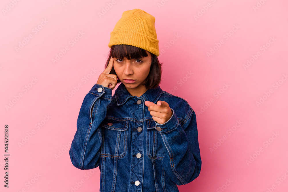 Young mixed race woman isolated on pink background pointing temple with finger, thinking, focused on a task. Young mixed race woman isolated on pink background pointing temple with finger, thinking, focused on a task.