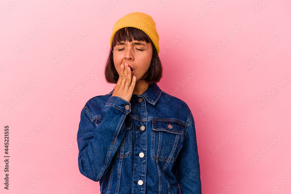 Young mixed race woman isolated on pink background yawning showing a tired gesture covering mouth with hand. Young mixed race woman isolated on pink background yawning showing a tired gesture covering mouth with hand.