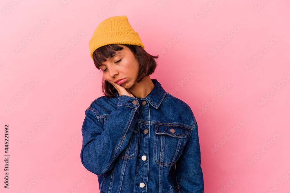 Young mixed race woman isolated on pink background who is bored, fatigued and need a relax day. Young mixed race woman isolated on pink background who is bored, fatigued and need a relax day.