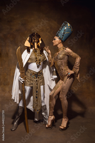 Photography Young woman in image of Nefertiti in art performance isolated on brown vintage background