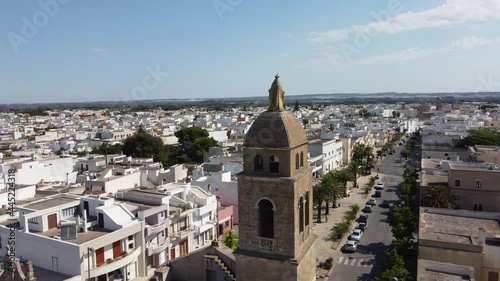 Aerial View of the Golden Madonna Statue over the Belltower of the Church SS. Maria Addolorata in Taviano, Apulia, Italy. photo