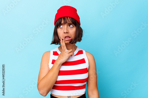 Young mixed race woman isolated on blue background having a strong teeth pain, molar ache.