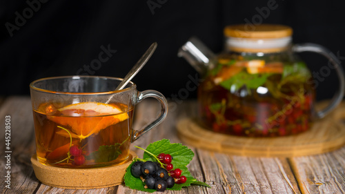 Fresh tasty berry tea on dark background. Image with selective focus